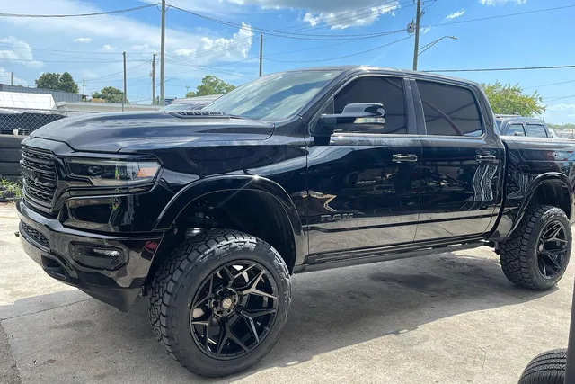 A black Ram Limited on a Rough Country air ride suspension kit and black wheels